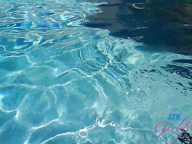 Babyfaced asian Mi Ha Doan swimming naked in the pool