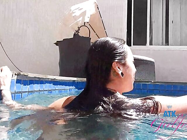 Babyfaced asian Mi Ha Doan swimming naked in the pool