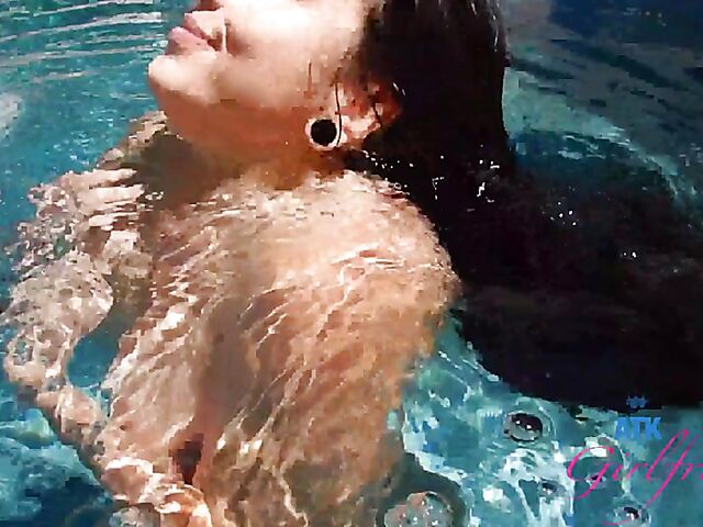 Babyfaced asian Mi Ha Doan swimming naked in the pool