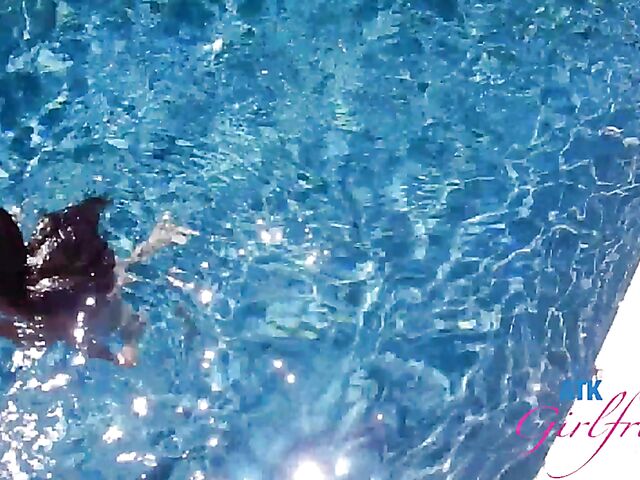 Babyfaced asian Mi Ha Doan swimming naked in the pool