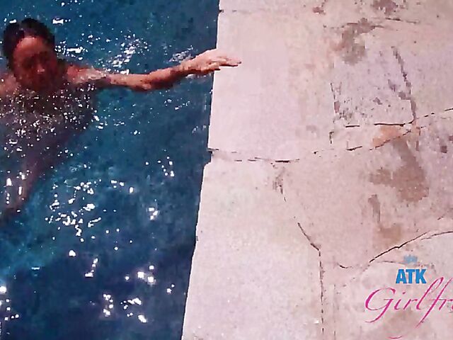 Babyfaced asian Mi Ha Doan swimming naked in the pool