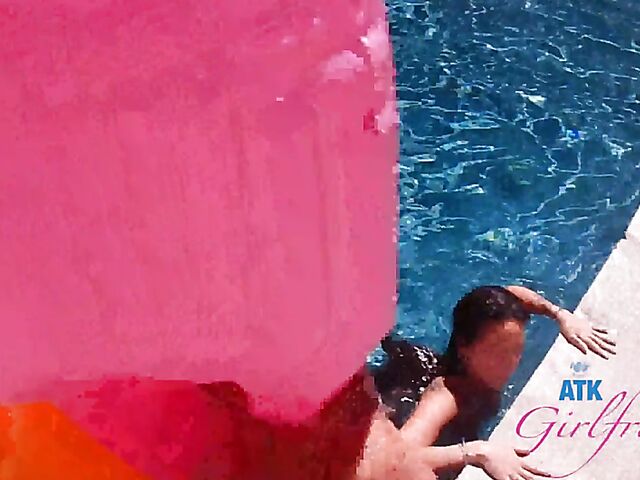 Babyfaced asian Mi Ha Doan swimming naked in the pool