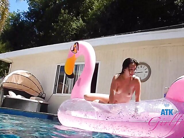 Babyfaced asian Mi Ha Doan swimming naked in the pool