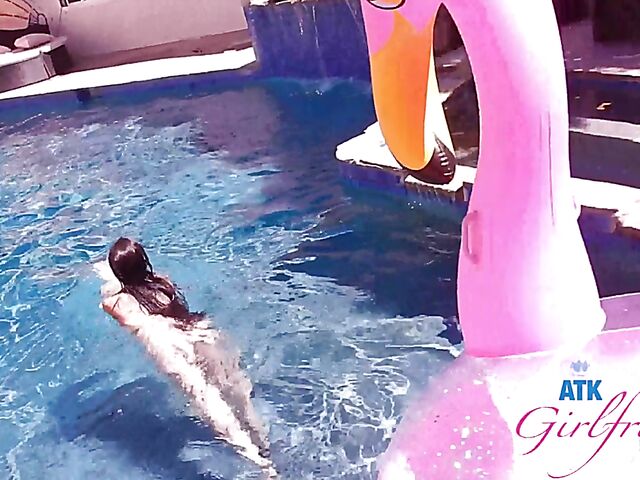 Babyfaced asian Mi Ha Doan swimming naked in the pool