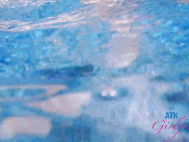 Babyfaced asian Mi Ha Doan swimming naked in the pool