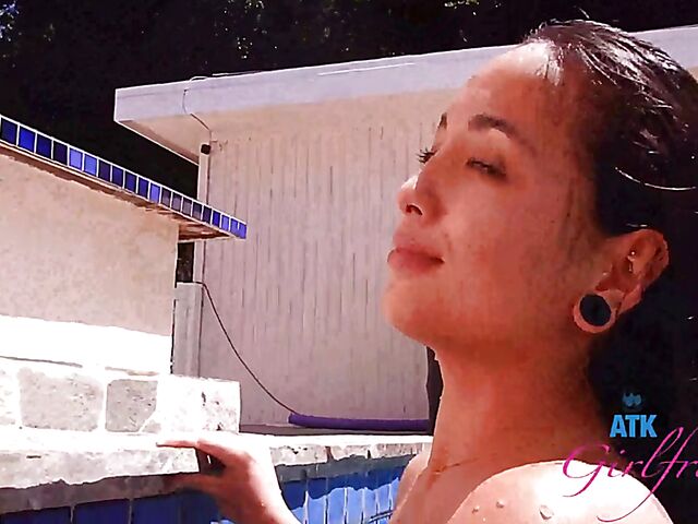 Babyfaced asian Mi Ha Doan swimming naked in the pool