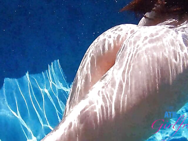 Babyfaced asian Mi Ha Doan swimming naked in the pool