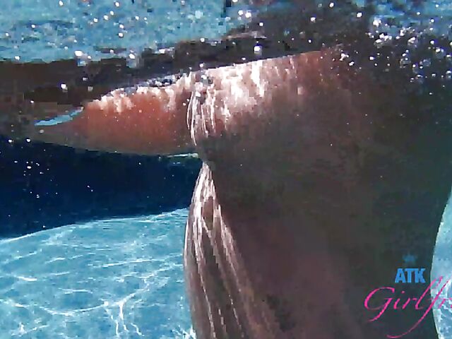 Babyfaced asian Mi Ha Doan swimming naked in the pool