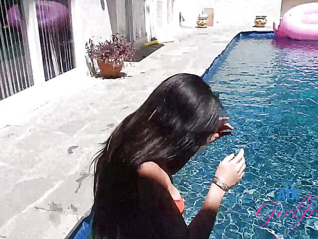 Babyfaced asian Mi Ha Doan swimming naked in the pool