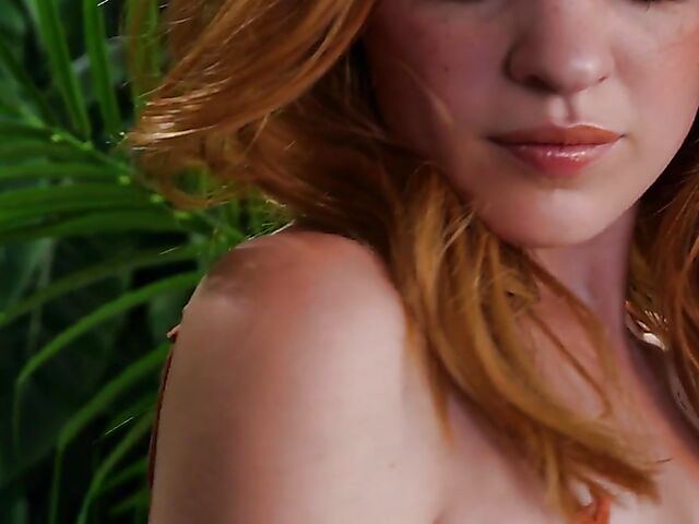 Sexy redhead Celeste Rasmussen takes off her bodysuit and shows her natural bush
