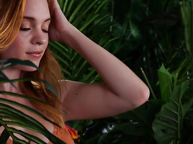 Sexy redhead Celeste Rasmussen takes off her bodysuit and shows her natural bush
