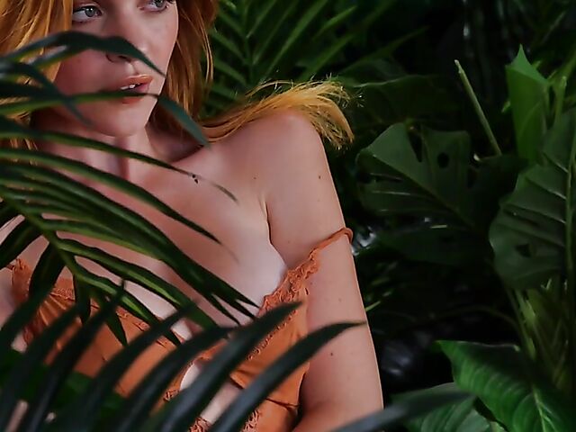 Sexy redhead Celeste Rasmussen takes off her bodysuit and shows her natural bush