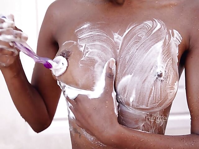 Wet ebony babe Katherina shaving pussy and legs under the shower