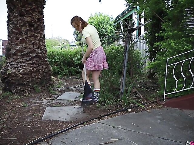 Naughty girl in a mini skirt Pixie Faye picking flowers and fingering herself