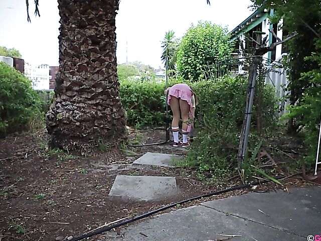 Naughty girl in a mini skirt Pixie Faye picking flowers and fingering herself