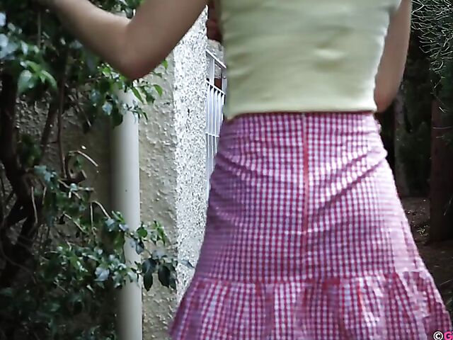 Naughty girl in a mini skirt Pixie Faye picking flowers and fingering herself