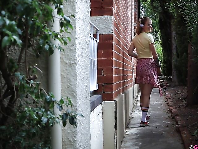 Naughty girl in a mini skirt Pixie Faye picking flowers and fingering herself