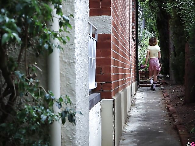 Naughty girl in a mini skirt Pixie Faye picking flowers and fingering herself