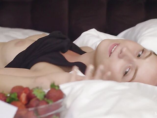 Solo blonde Bernie eating strawberries and fingering her pussy in her bed