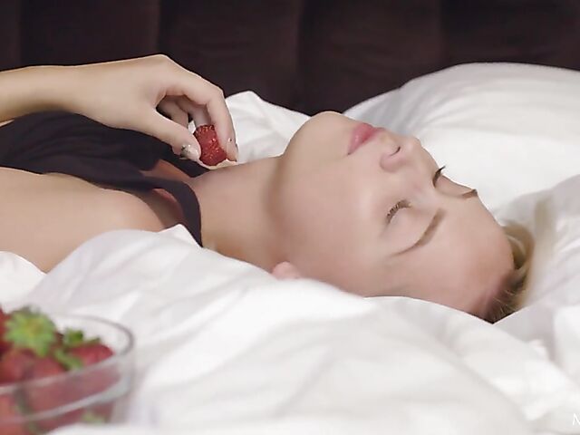 Solo blonde Bernie eating strawberries and fingering her pussy in her bed