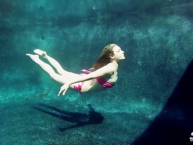 Taylor Dare takes off her pink bikini and poses nude underwater