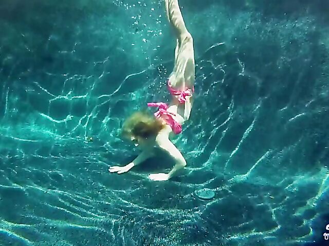 Taylor Dare takes off her pink bikini and poses nude underwater