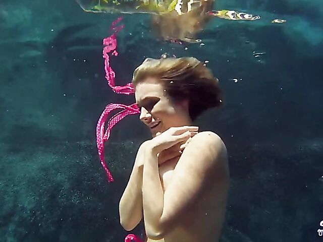 Taylor Dare takes off her pink bikini and poses nude underwater