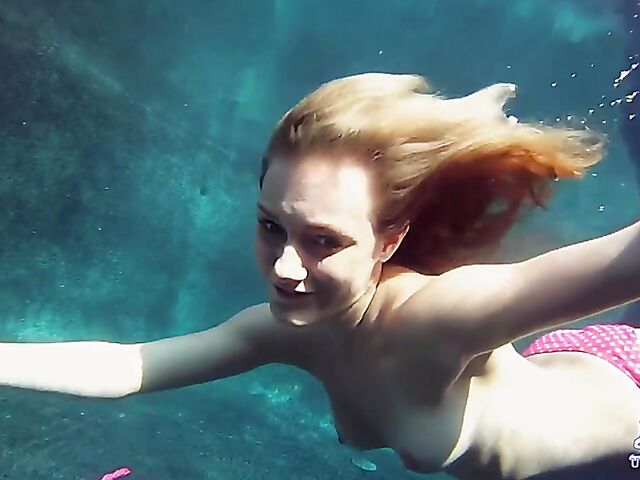 Taylor Dare takes off her pink bikini and poses nude underwater
