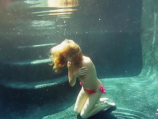 Taylor Dare takes off her pink bikini and poses nude underwater