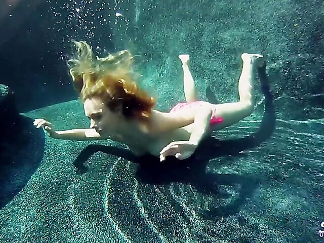Taylor Dare takes off her pink bikini and poses nude underwater