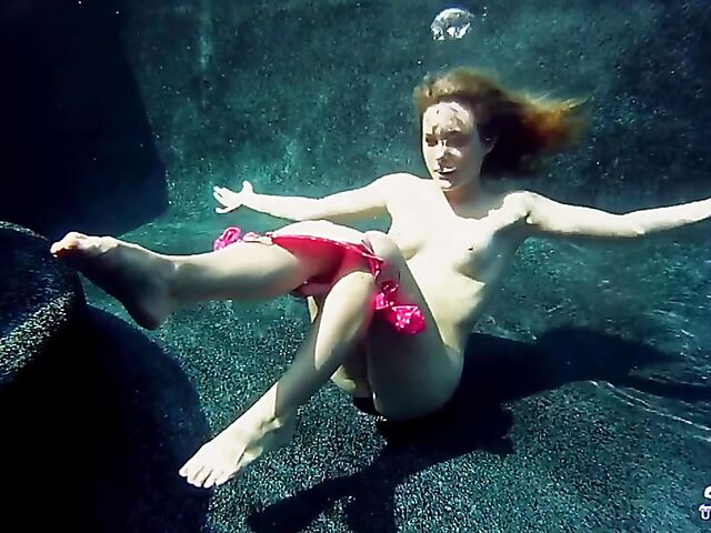 Taylor Dare takes off her pink bikini and poses nude underwater
