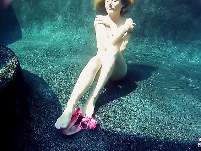Taylor Dare takes off her pink bikini and poses nude underwater