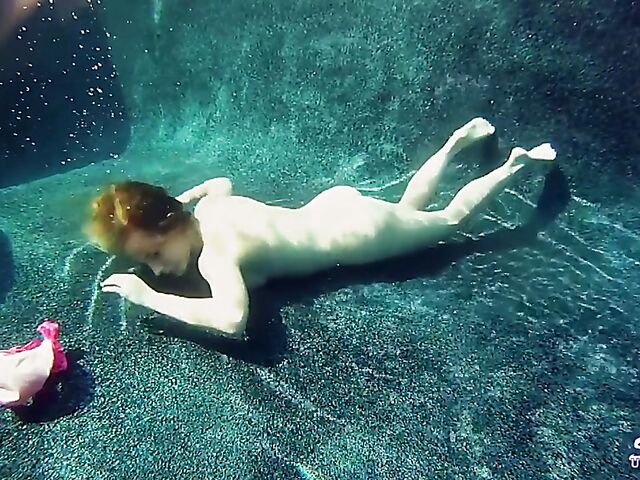 Taylor Dare takes off her pink bikini and poses nude underwater