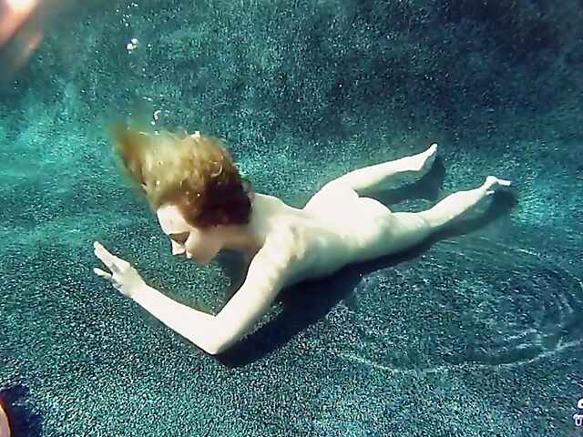 Taylor Dare takes off her pink bikini and poses nude underwater