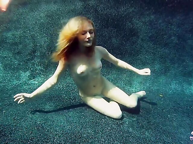 Taylor Dare takes off her pink bikini and poses nude underwater