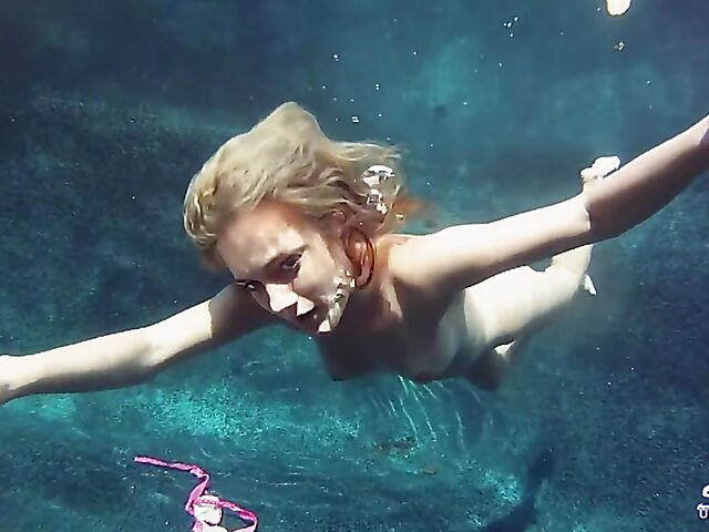 Taylor Dare takes off her pink bikini and poses nude underwater