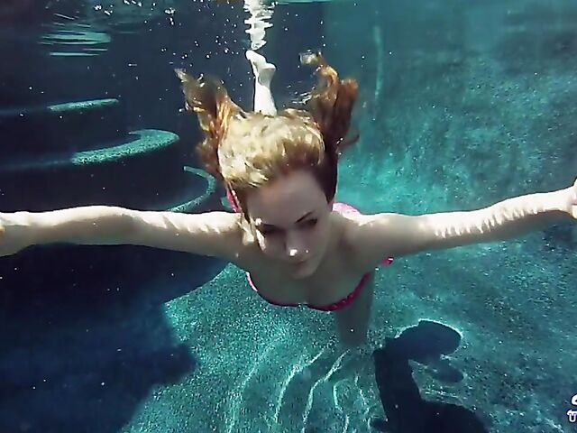 Taylor Dare takes off her pink bikini and poses nude underwater