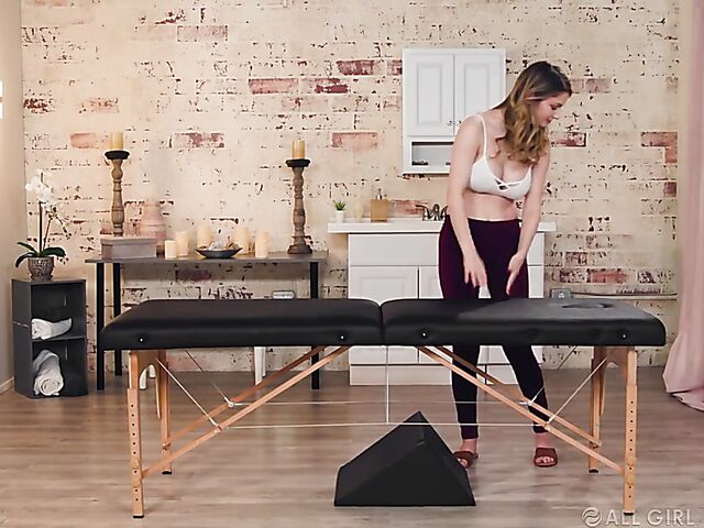 Lesbian masseuse Bunny Colby uses a massage bolster to eat Gia Derza's pussy from behind