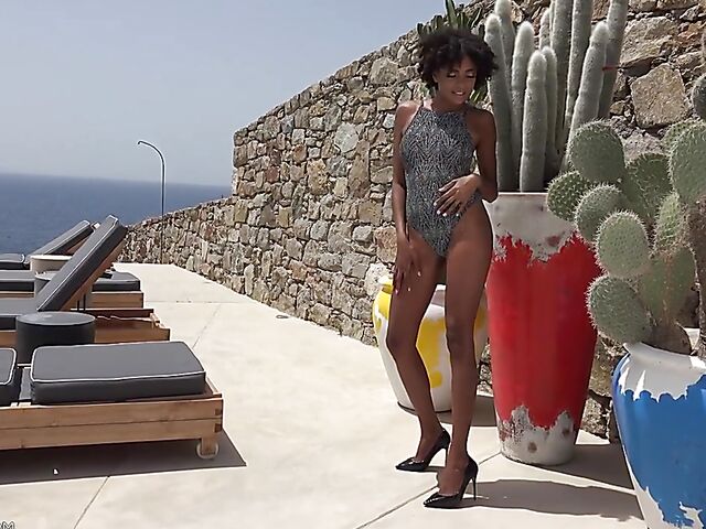 Perfect ebony babe Luna Corazon posing nude by the pool in Greece
