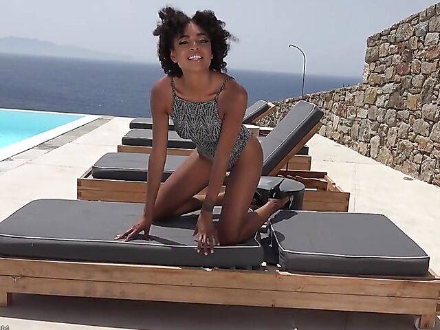 Perfect ebony babe Luna Corazon posing nude by the pool in Greece