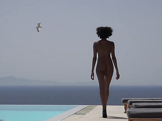 Perfect ebony babe Luna Corazon posing nude by the pool in Greece