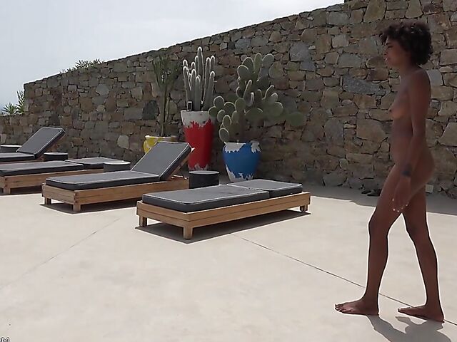 Perfect ebony babe Luna Corazon posing nude by the pool in Greece