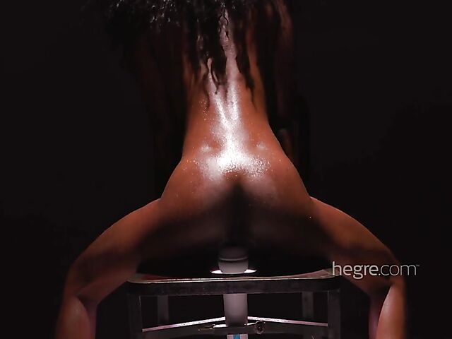 Sweaty ebony Katherina riding a chair with a magic wand in it