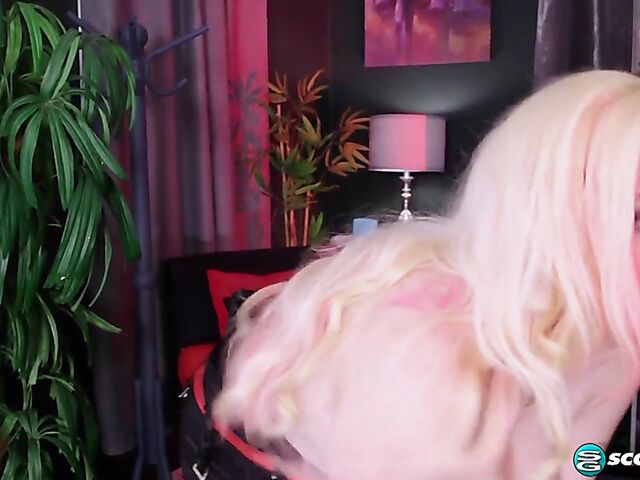 Pink hair blonde Suzumi Wilder is a chubby big tits woman who loves wearing fetish outfits and playing with herself