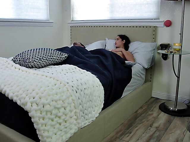 Brunette nurse Luz masturbating next to a sleeping guy in his bed