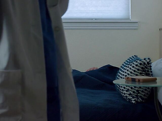 Brunette nurse Luz masturbating next to a sleeping guy in his bed