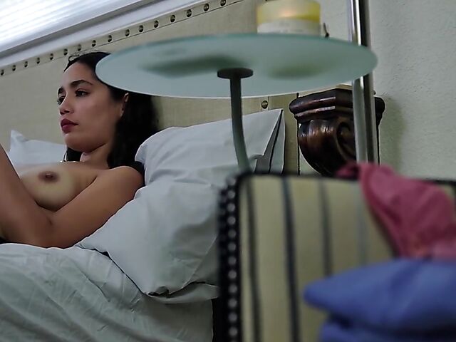 Brunette nurse Luz masturbating next to a sleeping guy in his bed