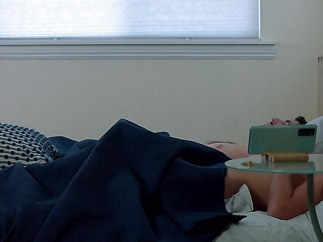 Brunette nurse Luz masturbating next to a sleeping guy in his bed