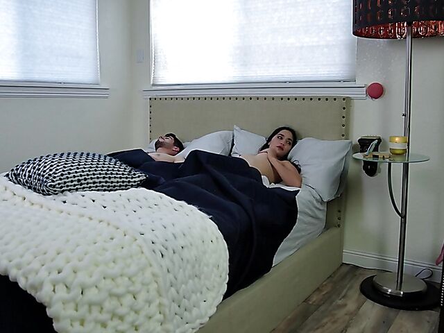 Brunette nurse Luz masturbating next to a sleeping guy in his bed