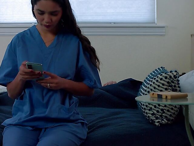 Brunette nurse Luz masturbating next to a sleeping guy in his bed